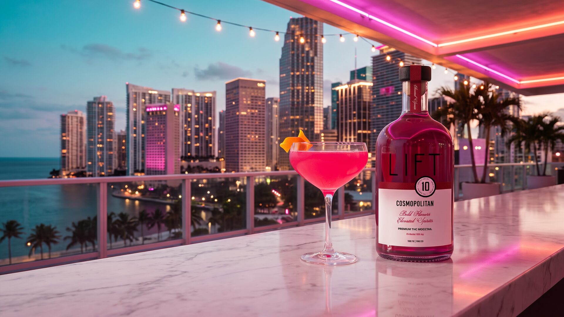 Miami rooftop cocktail lounge at dusk with the LIFT Cosmopolitan bottle and a hot pink cosmopolitan cocktail on a marble bar overlooking the illuminated Brickell skyline